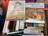 many books that are in a box on the floor