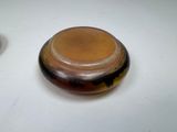 a small glass bowl with a lid on a table