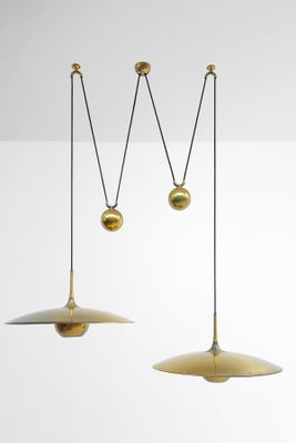 three brass pendant lights hanging from the ceiling