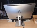 a dell computer monitor sitting on a desk in a room