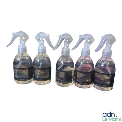 four bottles of cleaning products are lined up on a white surface