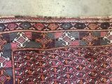 rug on the floor with a cat laying on top of it