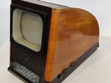 a small television sitting on top of a white table