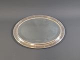 a silver tray with a mirror on it on a table