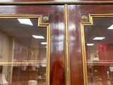a glass door with a clock on it in a room