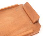 a wooden cutting board with a knife on top of it