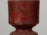 an old wooden container sitting on top of a table next to a white wall