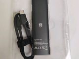 a small battery in the packaging with a charger attached