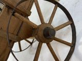 a wooden wagon with a wooden seat and a wooden wheel