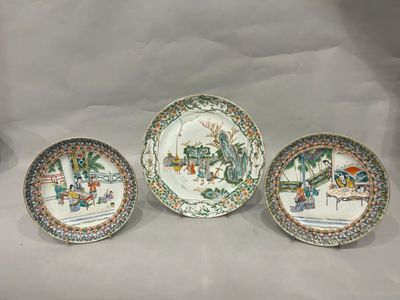 three plates with asian designs on them sitting on a white surface