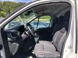 the interior of a car with the door open and the driver ' s seat down