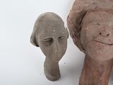two sculptures of a woman ' s head and a man ' s head