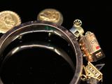 a close up of a ring with a lot of charms on it