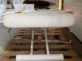 a white bed sitting on a pallet in a warehouse