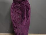 a mannequin wearing a purple skirt with buttons on it