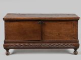 an old wooden chest with two doors and a drawer on the bottom