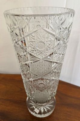 a clear glass vase sitting on a wooden table