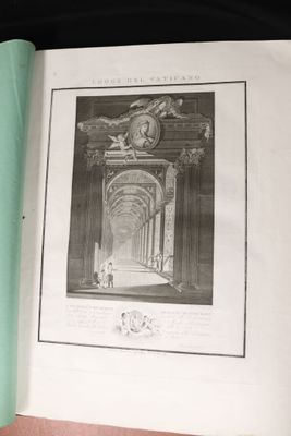 an open book with a picture of a building in the background