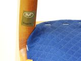 a close up of a wooden chair with a blue cover