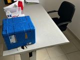 a blue box sitting on top of a white table next to a black chair