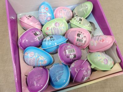a pink box filled with lots of colorful easter eggs