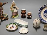 many different types of pottery on display on the table