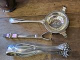 three spoons and a measuring spoon on a table