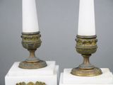 two candles that are sitting on top of a white box