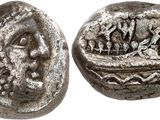 a close up of a silver coin with a face on it
