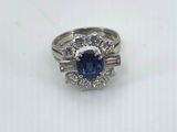 a blue sapphire and diamond ring on a white background