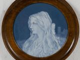 painting of a woman ' s profile in a wooden frame on a wall