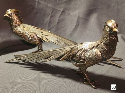 pair of antique brass pheasants on a grey background