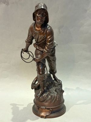 bronze statue of a boy with a dog on a rock