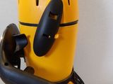 a yellow and black blow dryer sitting on a wooden table