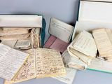 an open box filled with lots of old papers sitting on top of a table