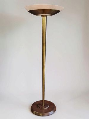 a tall brass table with a marble top on a wooden base