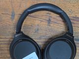 a pair of headphones sitting on top of a wooden table