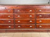 a large wooden dresser with many drawers on it