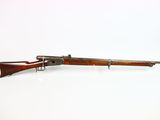 an old rifle on a white surface with a white background