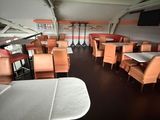 many tables and chairs in the dining area of this restaurant
