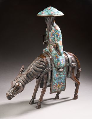 statue of a woman riding a horse with a hat on her head