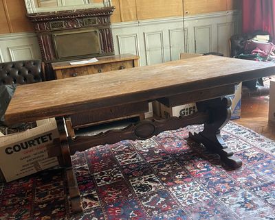 a large wooden table in the middle of a living room