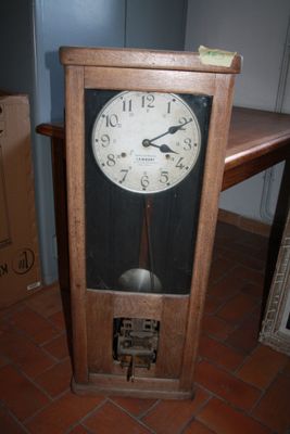 a clock that is sitting on the floor next to a table