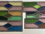four stained glass squares with different colors of paint on them