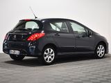 the back end of a small black car parked in a room