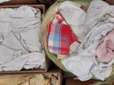 a box full of clothes sitting on the floor next to a pair of shoes