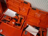 an orange tool box with tools in it on a table