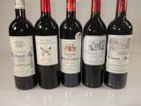 six bottles of red wine are lined up on a counter