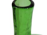 a green glass vase with a black rim sitting on a white surface