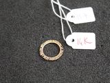 une bague à laquelle est accrochée une étiquette, posée sur une table